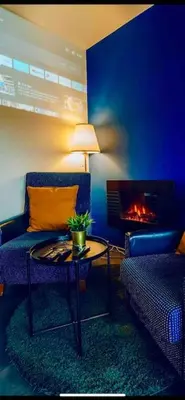 a living room with a couch and a table and a fireplace at Lovely 3BD - Rooftop - Jacuzzi&Sauna in Prague