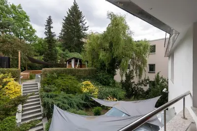 a view of a garden from the balcony of a house at Lovely 3BD - Rooftop - Jacuzzi&Sauna in Prague