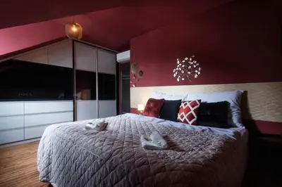 a bedroom with a large bed with two towels on it at Golden Tree Loft in the Heart of Prague in Prague