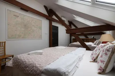 a bedroom with two beds and a map on the wall at Golden Tree Loft in the Heart of Prague in Prague