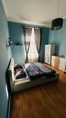 a bedroom with a bed in front of a window at I.P.Pavlova in Prague