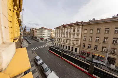 a view of a city street with a train at I.P.Pavlova in Prague