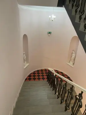 a stairway with a checkerboard pattern on the wall at Prague National Museum Apartment in Prague