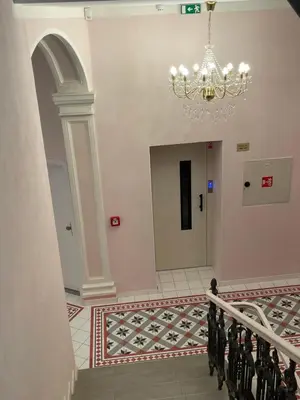 a hallway with a chandelier in a building at Prague National Museum Apartment in Prague