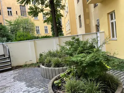 a courtyard with plants and a building at Prague National Museum Apartment in Prague