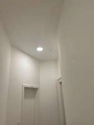 a room with a white wall and a ceiling at Prague National Museum Apartment in Prague