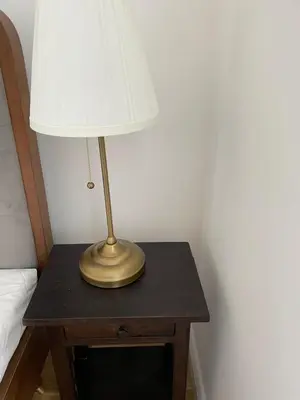 a lamp sitting on a table next to a bed at Prague National Museum Apartment in Prague