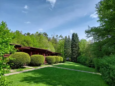 a garden with a row of nicely trimmed bushes at ZÁTOKA Živohošť - Chaty in Chotilsko