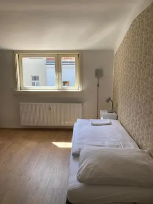 a bedroom with a large bed and a window at Žižkov tower suites in Prague