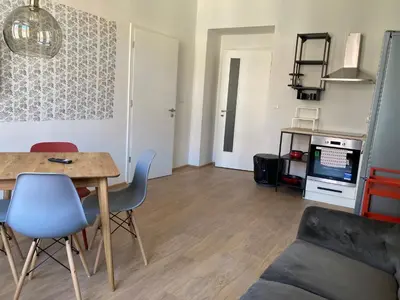 a living room with a table and a couch at Žižkov tower suites in Prague