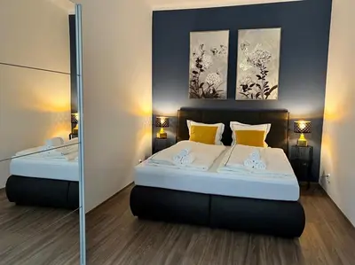 a bedroom with two beds and two paintings on the wall at PRAGUE’s HIDDEN PEARL in Prague