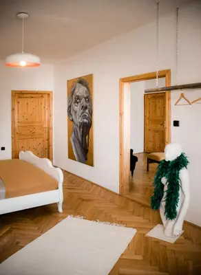 a bedroom with a bed and a painting on the wall at Kiki & Luky family apartment by Prague Castle in Prague
