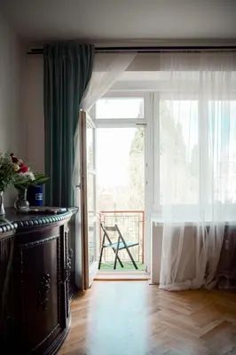 an open door to a balcony with a window at Kiki & Luky family apartment by Prague Castle in Prague