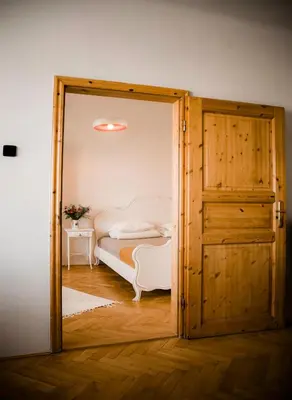 an open door to a bedroom with a bed at Kiki & Luky family apartment by Prague Castle in Prague