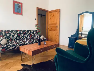 a living room with a couch and a coffee table at Kiki & Luky family apartment by Prague Castle in Prague