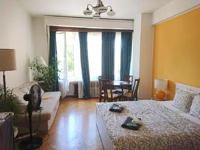 a living room with a bed and a couch and a table at Cozy studio in the heart of old Prague near the Charles Bridge in Prague