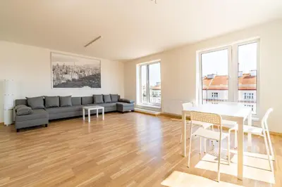a living room with a couch and a table at Penthouse # 81 with panoramic city view in Elite Rezidence with free parking in Prague