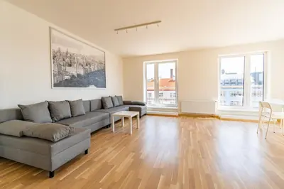 a living room with a couch and a table at Penthouse # 81 with panoramic city view in Elite Rezidence with free parking in Prague