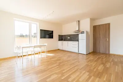 a kitchen and dining room with a table and chairs at Penthouse # 81 with panoramic city view in Elite Rezidence with free parking in Prague