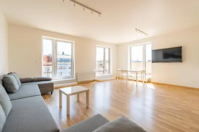 a living room with a couch and a table at Penthouse # 81 with panoramic city view in Elite Rezidence with free parking in Prague