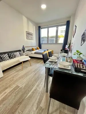 a large empty room with three doors on a wall at VIT Apartment - Free Parking - O2 Arena in Prague