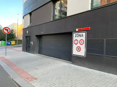 a building with two garage doors and a speed limit sign at VIT Apartment - Free Parking - O2 Arena in Prague