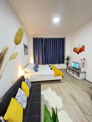 a bedroom with a large bed with a yellow blanket at VIT Apartment - Free Parking - O2 Arena in Prague