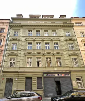 a large building with cars parked in front of it at Black Pearl by Vysehrad Castle in Prague