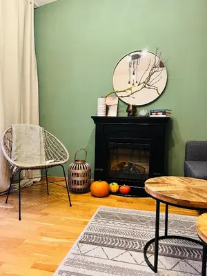 a living room with a fireplace and a mirror at Black Pearl by Vysehrad Castle in Prague