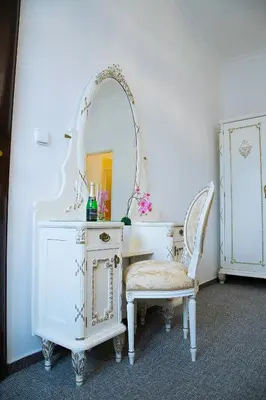 a white dressing table with a mirror and a chair at Old Prague House in Prague