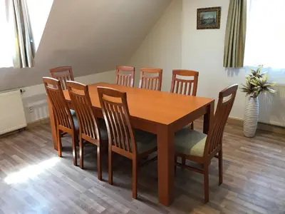 a wooden dining room table and chairs in a room at Old Prague House in Prague