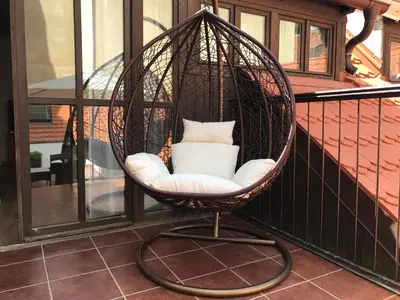 a hanging chair with a pillow on a balcony at Old Prague House in Prague