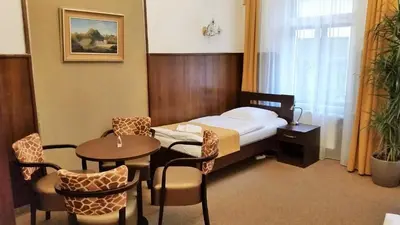 a hotel room with a bed and a table and chairs at Old Prague House in Prague