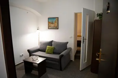 a living room with a chair and a table at Old Prague House in Prague