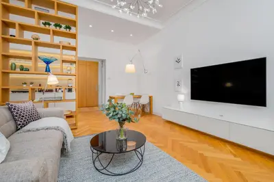 a living room with a couch and a tv at Prague Days - City Central One-bedroom Apartment right next to Old Town Square in Prague