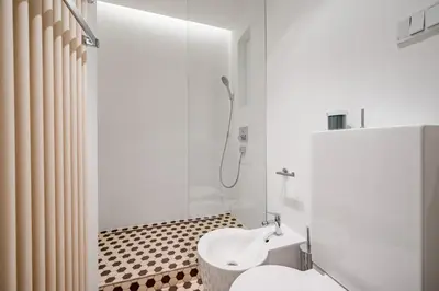 a bathroom with a shower and a toilet and a sink at Prague Days - City Central One-bedroom Apartment right next to Old Town Square in Prague
