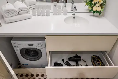 a kitchen counter with a sink and a washing machine at Prague Days - City Central One-bedroom Apartment right next to Old Town Square in Prague