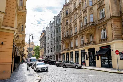 a city street with cars parked on the side of the road at Prague Days - City Central One-bedroom Apartment right next to Old Town Square in Prague