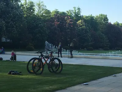 a bike parked on the grass in a park at Apartmá v srdci Poděbrad in Poděbrady