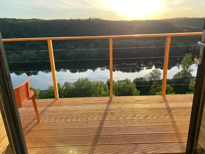 a balcony with a view of a lake at Chatka - A - Vyhlídka nad řekou in Zdiby