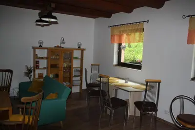 a living room with a table and chairs at Chata na řece Sázavě in Samopše