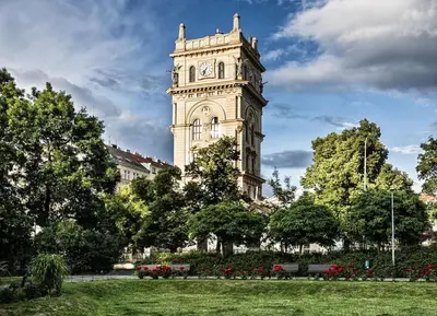 a tall tower with a clock on a building at Cozy studio in Vinohrady in Prague
