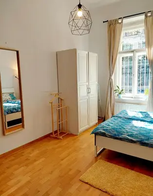 a bedroom with a bed and a mirror on the wall at Cozy studio in Vinohrady in Prague