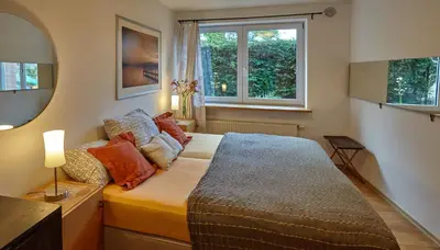 a bedroom with a bed and two windows at Villa In Bio Garden - You Will Save Money Here in Prague
