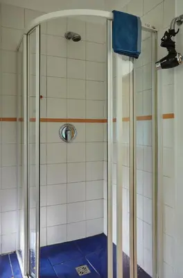 a shower with a glass door in a bathroom at Villa In Bio Garden - You Will Save Money Here in Prague