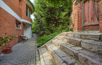 a brick building with stairs next to a building at Villa In Bio Garden - You Will Save Money Here in Prague