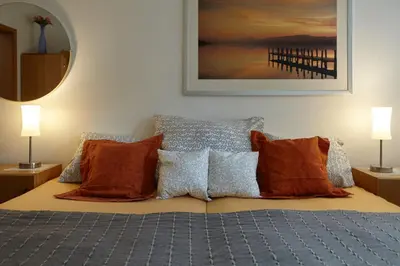 a bedroom with a bed with orange pillows at Villa In Bio Garden - You Will Save Money Here in Prague