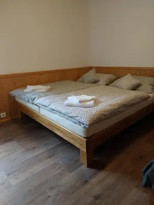 a bed with two towels on it in a room at ZÁTOKA Živohošť - Apartmány in Chotilsko