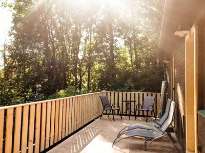 a patio with two chairs and a table on a deck at ZÁTOKA Živohošť - Apartmány in Chotilsko