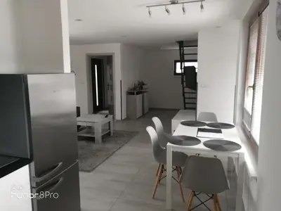 a kitchen and living room with a table and chairs at Ubytování Záluží in Kozlovice